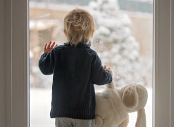 boy looks out window
