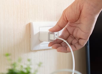plugging a charger into the wall